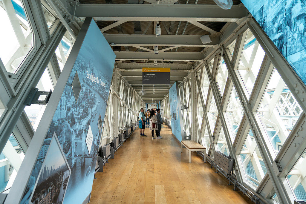 Visitors on the glass floor walkway inside Tower Bridge
