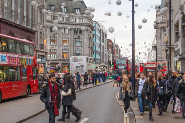 Shoppers under illuminated ball lights on Oxford Street